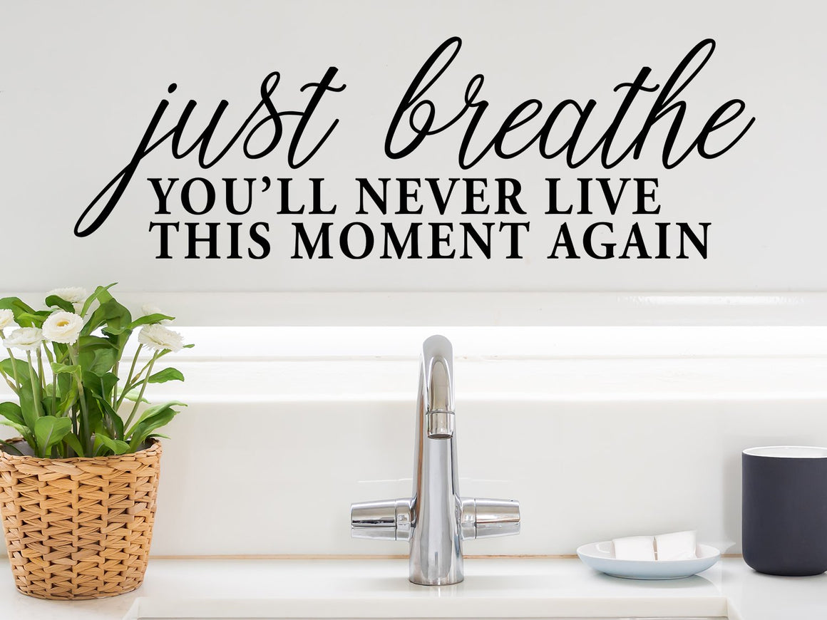 Wall decals for the bathroom that say ‘just breath you'll never live this moment again’ on a bathroom wall.