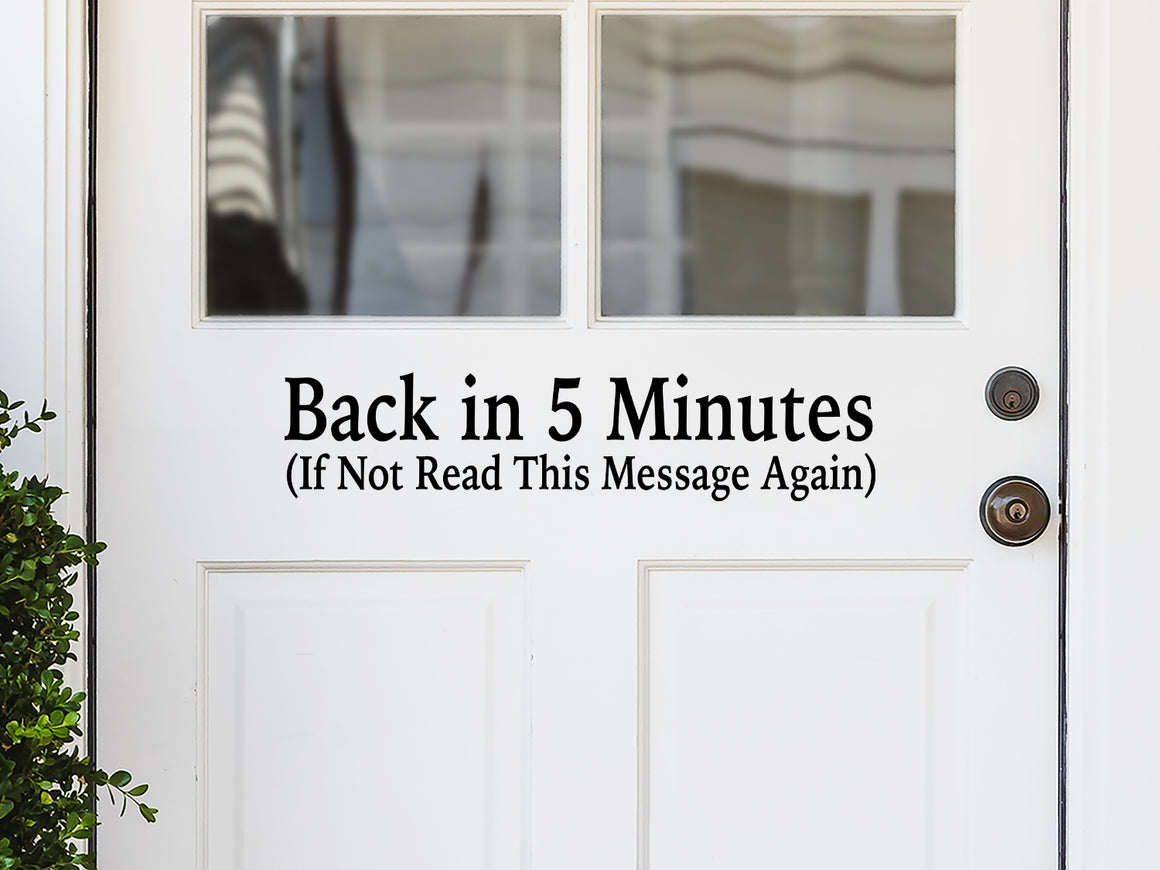 Front door decal that says, ‘Back In Five Minutes If Not Read This Message Again’ on a front porch door. 