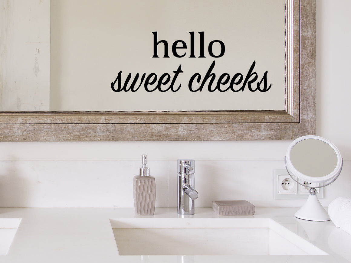 Wall decals for bathroom that say ‘Hello Sweet Cheeks’ in a bold font on a bathroom wall.