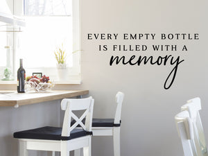 Wall decals for kitchen that say ‘Every Empty Bottle Is Filled With A Memory’ in a script font on a kitchen wall.