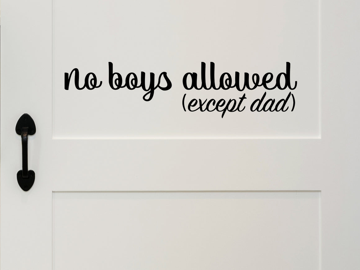 Wall decal for kids that says ‘No Boys Allowed Except Dad’ in a cursive font on a kid’s room wall. 