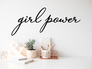 Wall decal for the office that says ‘Girl Power’ in a cursive font on an office wall.