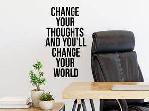Wall decal for the office that says ‘Change Your Thoughts And You'll Change Your World’ in a print font on an office wall.