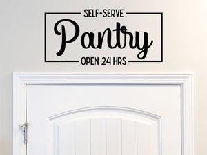 Decorative wall decal that says ‘Self-Serve Pantry Open 24 Hours’ on a kitchen wall.