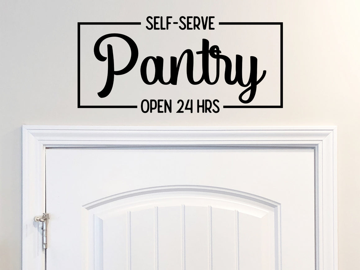 Decorative wall decal that says ‘Self-Serve Pantry Open 24 Hours’ on a kitchen wall.