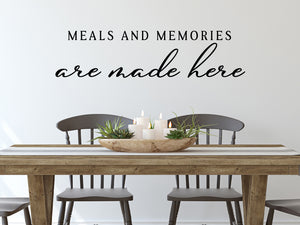 Wall decals for kitchen that say ‘Meals And Memories Are Made Here’ in a script font on a kitchen wall.