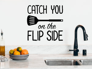 Wall decals for kitchen that say ‘catch you on the flip side’ on a kitchen wall.