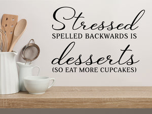 Wall decals for kitchen that say ‘Stressed Spelled Backwards Is Desserts So Eat More Cupcakes’ on a kitchen wall.