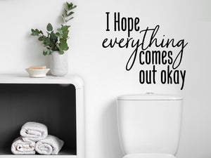 Wall decals for bathroom that say ‘I Hope Everything Comes Out Okay’ in a script font on a bathroom wall.