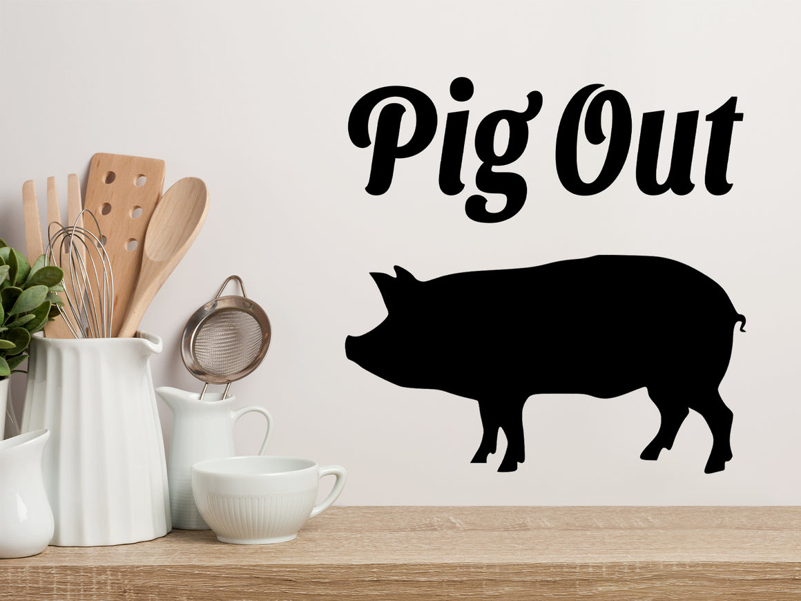 Decorative wall decal that says ‘Pig Out’ on a kitchen wall.