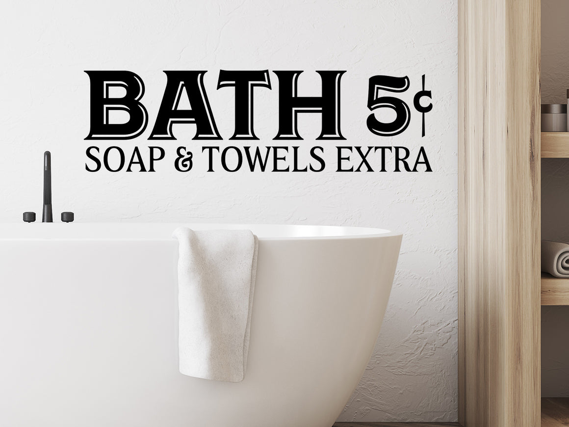 Wall decal for bathroom that says ‘Bath 5-cents. Soap & Towels Extra' on a bathroom wall.