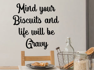 Decorative wall decal that says ‘Mind Your Biscuits And Life Will Be Gravy’ on a kitchen wall.