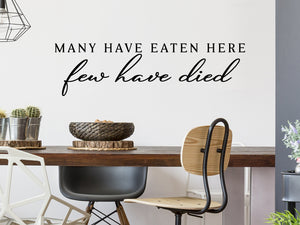 Wall decals for kitchen that say ‘Many Have Eaten Here Few Have Died’ in a script font on a kitchen wall.