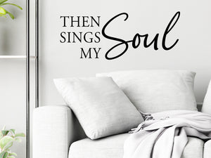 Living room wall decals that say ‘Then Sings My Soul’ in a script font on a living room wall. 