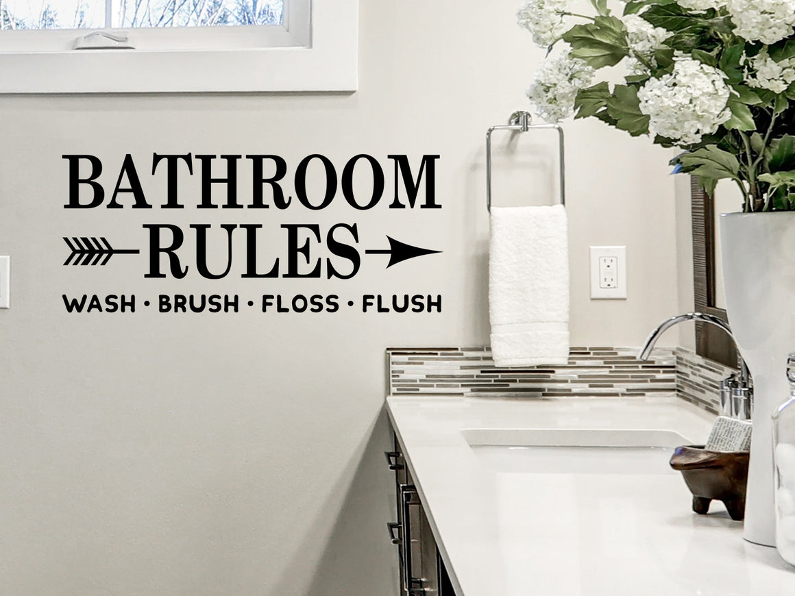 Wall decal for bathroom that says ‘Bathroom Rules Wash Brush Floss Flush’ on a bathroom wall.