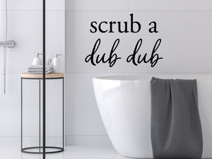 Wall decals for bathroom that say ‘Scrub A Dub Dub’ in a script font on a bathroom wall.