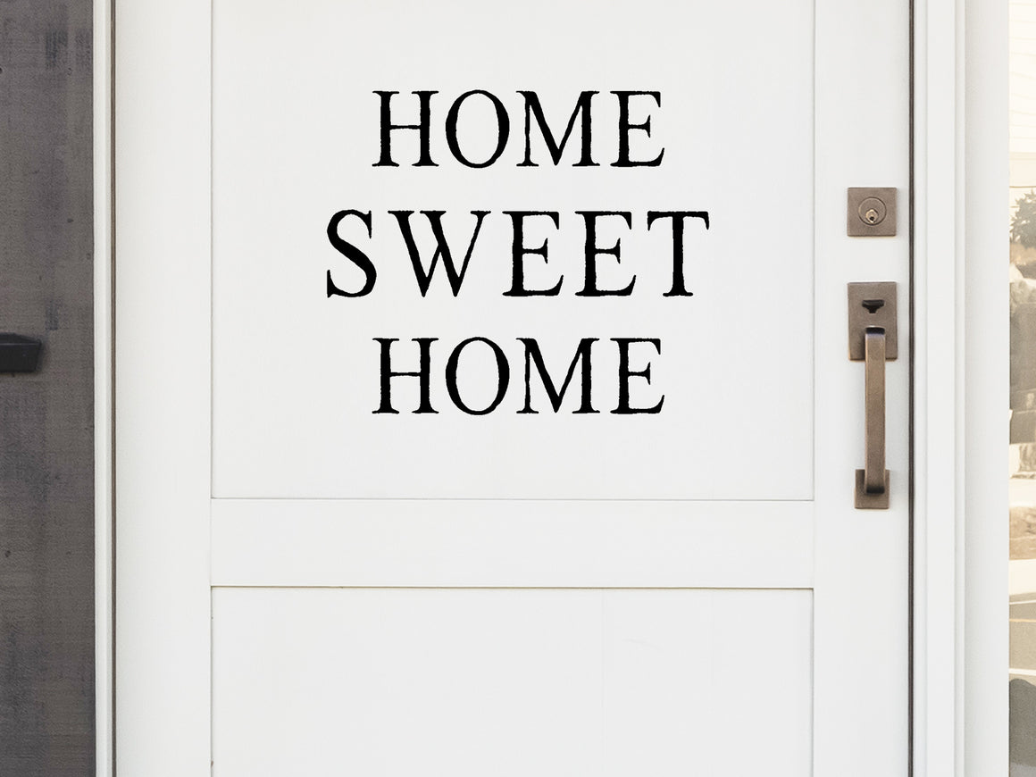 Front door decal that says, ‘Home Sweet Home’ in a block font on a front porch door. 
