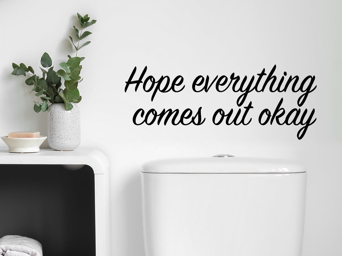 Decorative wall decal that says ‘Hope Everything Comes Out Okay’ on an office wall.