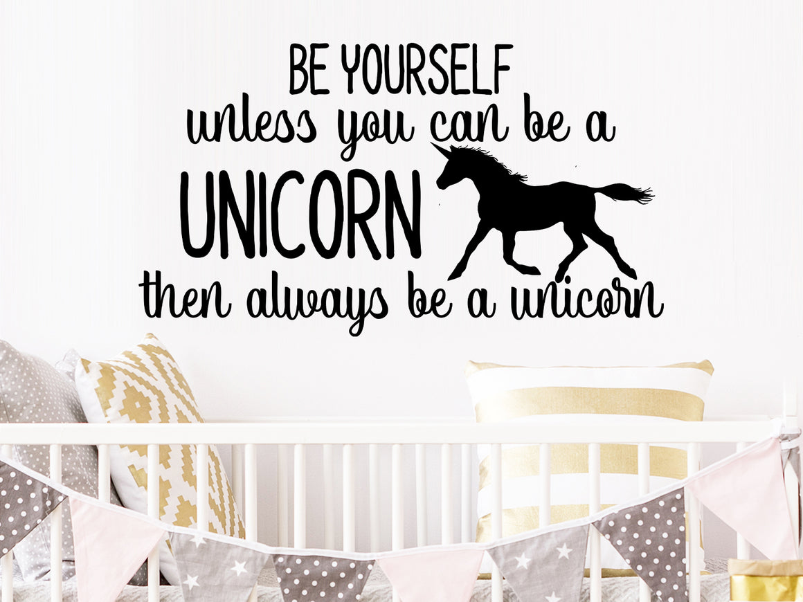 Wall decal for kids that says ‘Be yourself unless you can be a unicorn then always be a unicorn’ on a kid’s room wall. 