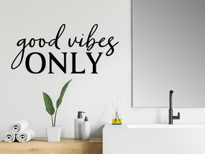 Wall decals for bathroom that say ‘Good Vibes Only’ in a script font on a bathroom wall.