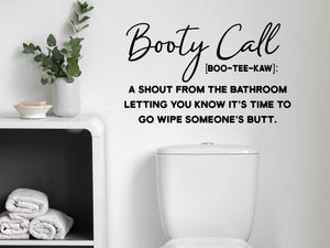 Wall decals for bathroom that say ‘Booty Call Definition’ in a script font on a bathroom wall.