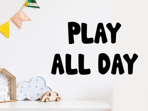 Wall decal for kids that says ‘Play all day’ on a kid’s room wall. 