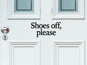 Front door decal that says, ‘Shoes off please’ in a print font on a front porch door.