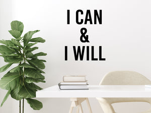 Wall decal for the office that says ‘I Can & I Will’ in a bold font on an office wall.