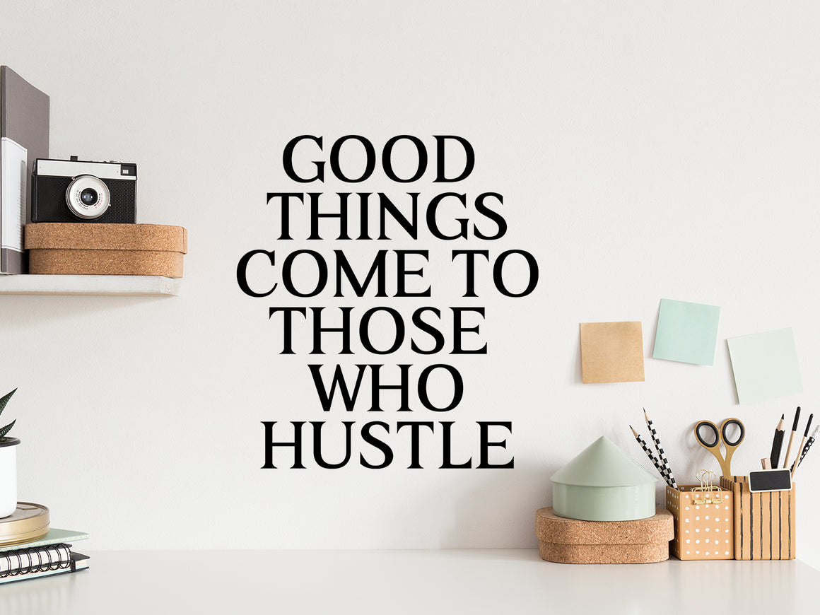 Wall decal for the office that says ‘Good Things Come To Those Who Hustle’ in a print font on an office wall.