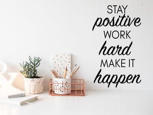 Wall decal for the office that says ‘Stay Positive Work Hard Make It Happen’ in a script font on an office wall.