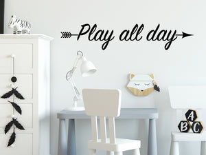 Wall decal for kids that says ‘Play All Day’ with an arrow on a kid’s room wall. 