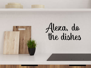 Wall decals for kitchen that say ‘Alexa Do The Dishes’ in a script font on a kitchen wall.