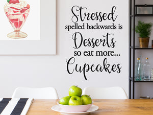 Decorative wall decal that says ‘Stressed Spelled Backwards Is Desserts So Eat More Cupcakes’ on a kitchen wall.