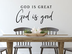 Wall decals for kitchen that say ‘God is Great, God Is Good’ in a script font on a kitchen wall.