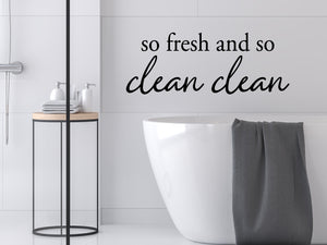 Wall decals for bathroom that say ‘So Fresh And So Clean Clean’ in a modern design on a bathroom wall.