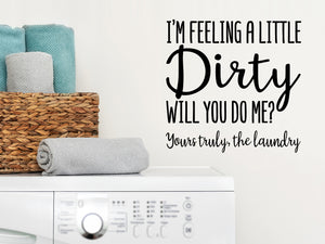 Laundry room wall decal that says ‘I'm Feeling Dirty Will You do Me? Yours Truly The Laundry’ on a laundry room wall.