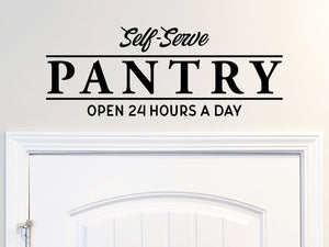 Decorative wall decal that says ‘Self-Serve Pantry Open 24 Hours A Day’ on a kitchen wall.