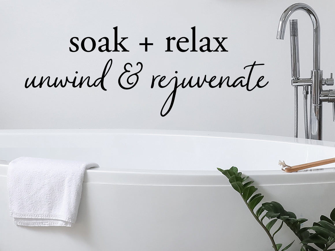 Wall decals for bathroom that say ‘Soak Relax Unwind Rejuvenate’ in a script font on a bathroom wall.