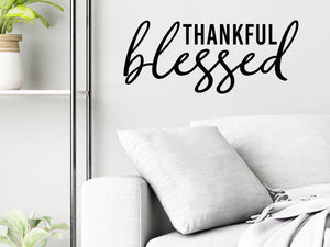 Living room wall decals that say ‘Thankful & Blessed’ on a living room wall. in a script font. 