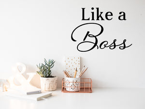 Wall decal for the office that says ‘Like A Boss’ in a script font on an office wall.