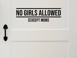 Wall decal for kids that says ‘No Girls Allowed Except Mom’ in a print font on a kid’s room wall. 