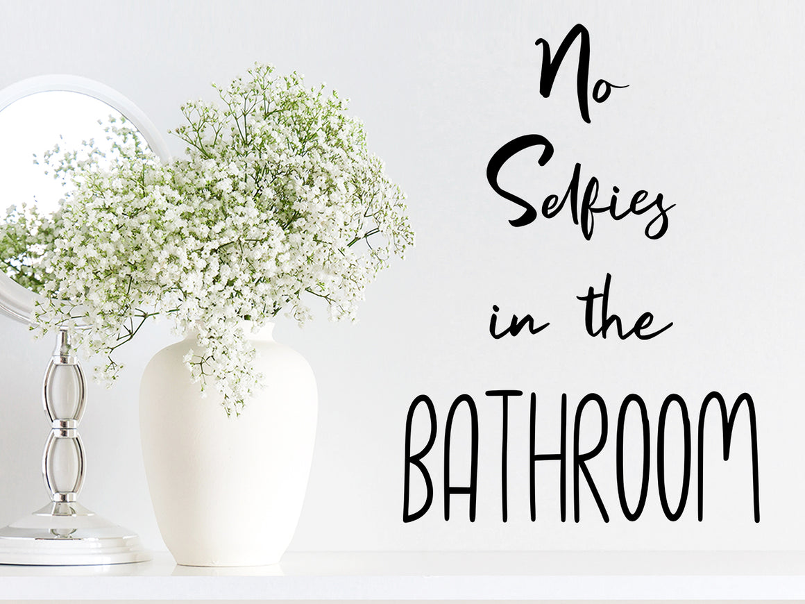 Wall decals for bathroom that say ‘no selfies in the bathroom’ on a bathroom wall.