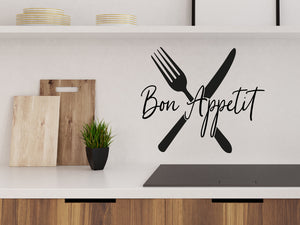 Wall decals for kitchen that say ‘Bon Appetit’ with a picture of a knife and fork on a kitchen wall.