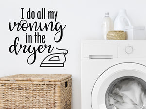 Decorative wall decal that says ‘I Do All My Ironing In The Dryer’ on a laundry room wall.