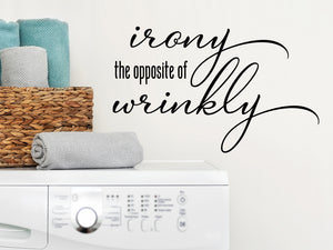 Laundry room wall decal that says ‘Irony The Opposite Of Wrinkly’ in cursive font on a laundry room wall.