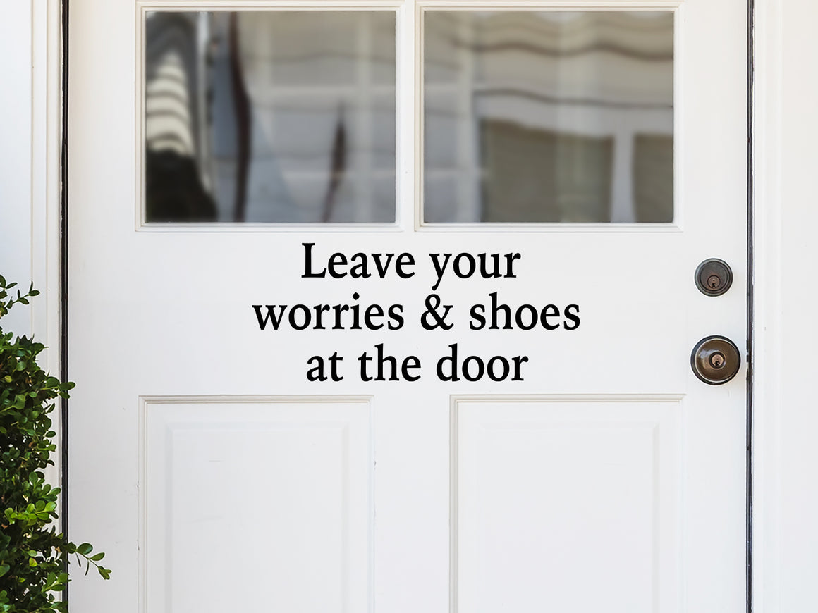 Front door decal that says, ‘Leave Your Worries And Shoes At The Door Print’ on a front porch door. 