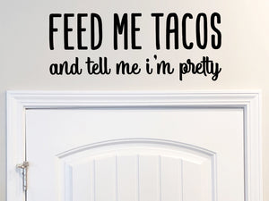 Wall decals for kitchen that say ‘feed me tacos and tell me i'm pretty’ on a kitchen wall.