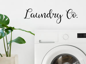 Laundry room wall decal that says ‘Laundry Co’ on a laundry room wall.