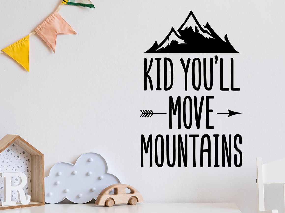 Wall decal for kids that says ‘Kid You'll Move Mountains’ in a print font on a kid’s room wall. 