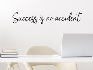 Wall decal for the office that says ‘Success Is No Accident’ in a cursive font on an office wall.